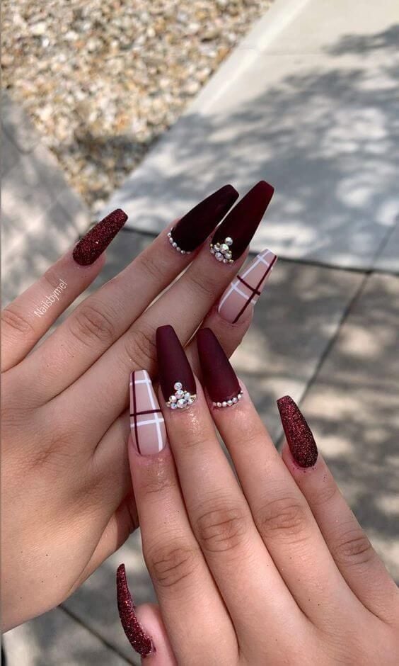 Burgundy nails with glitter and rhinestones and plaid design