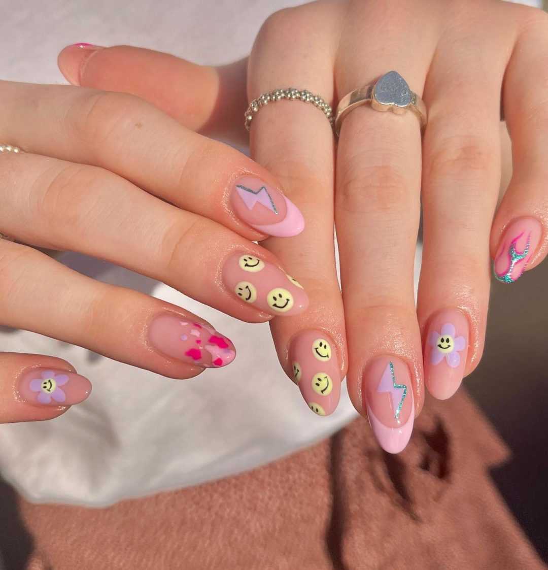 Cute pastel pink smiley face nails.