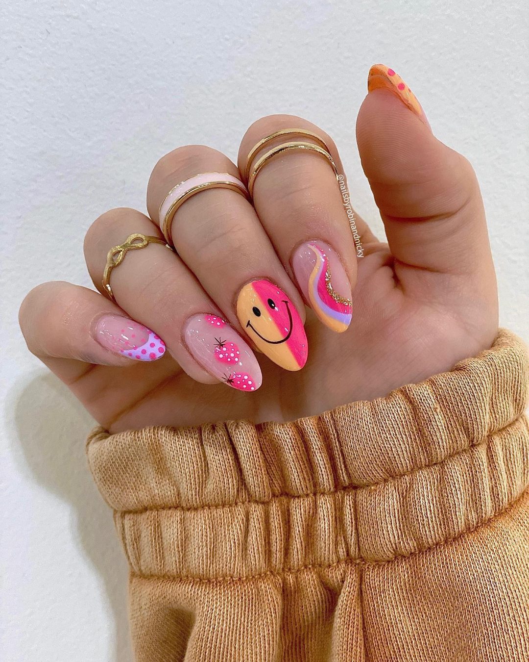 Cute hot pink smiley face nails with strawberries.