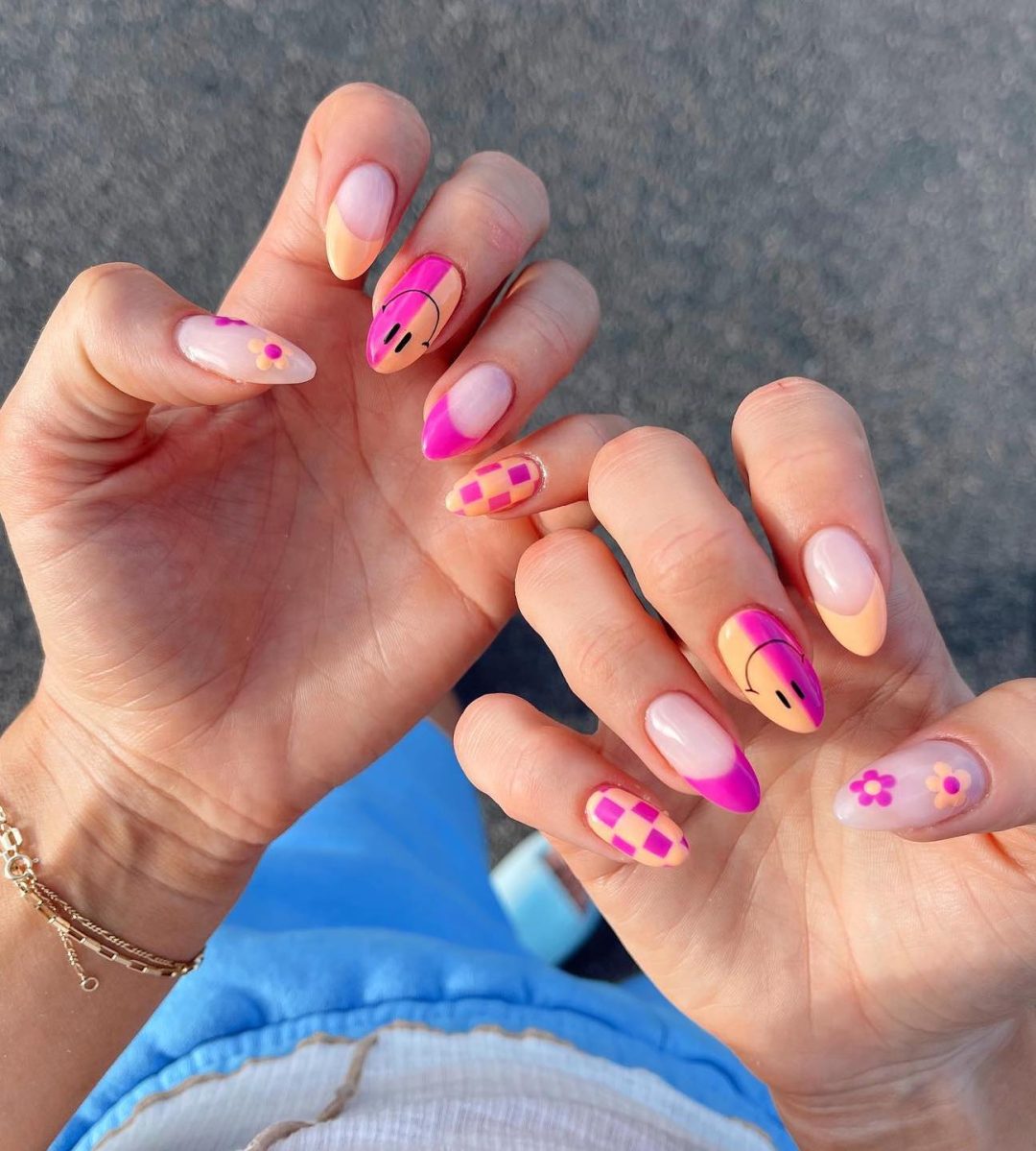 Hot pink and peach smiley face nails.