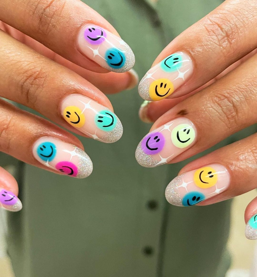 Cute colorful smiley face nails.