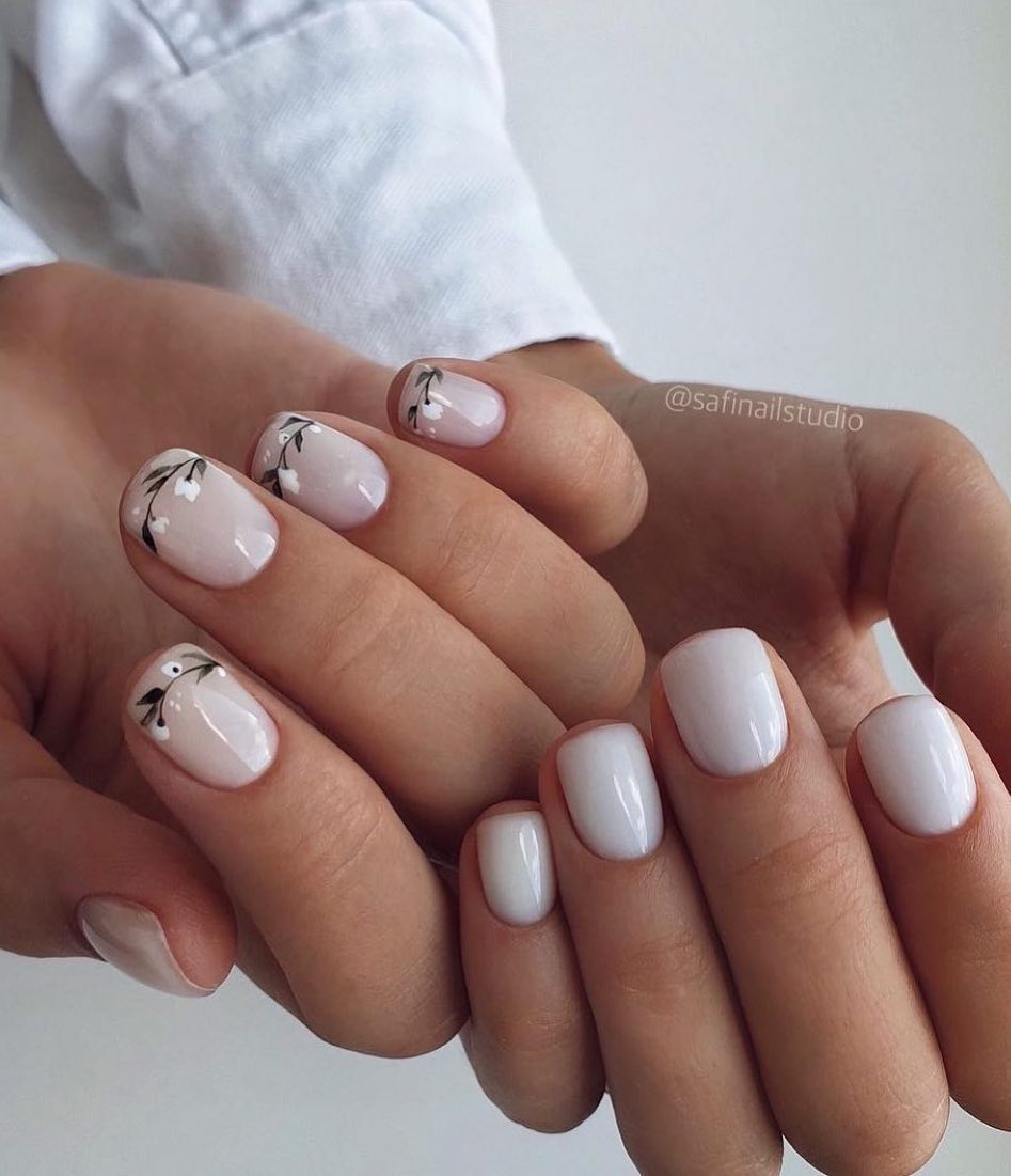 Short white nails with flower art.