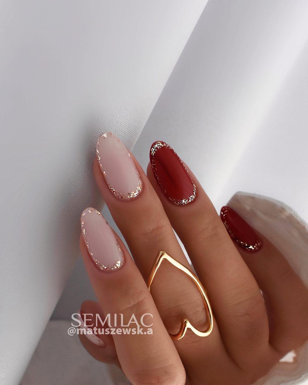 Chic neutral and burgundy nails.