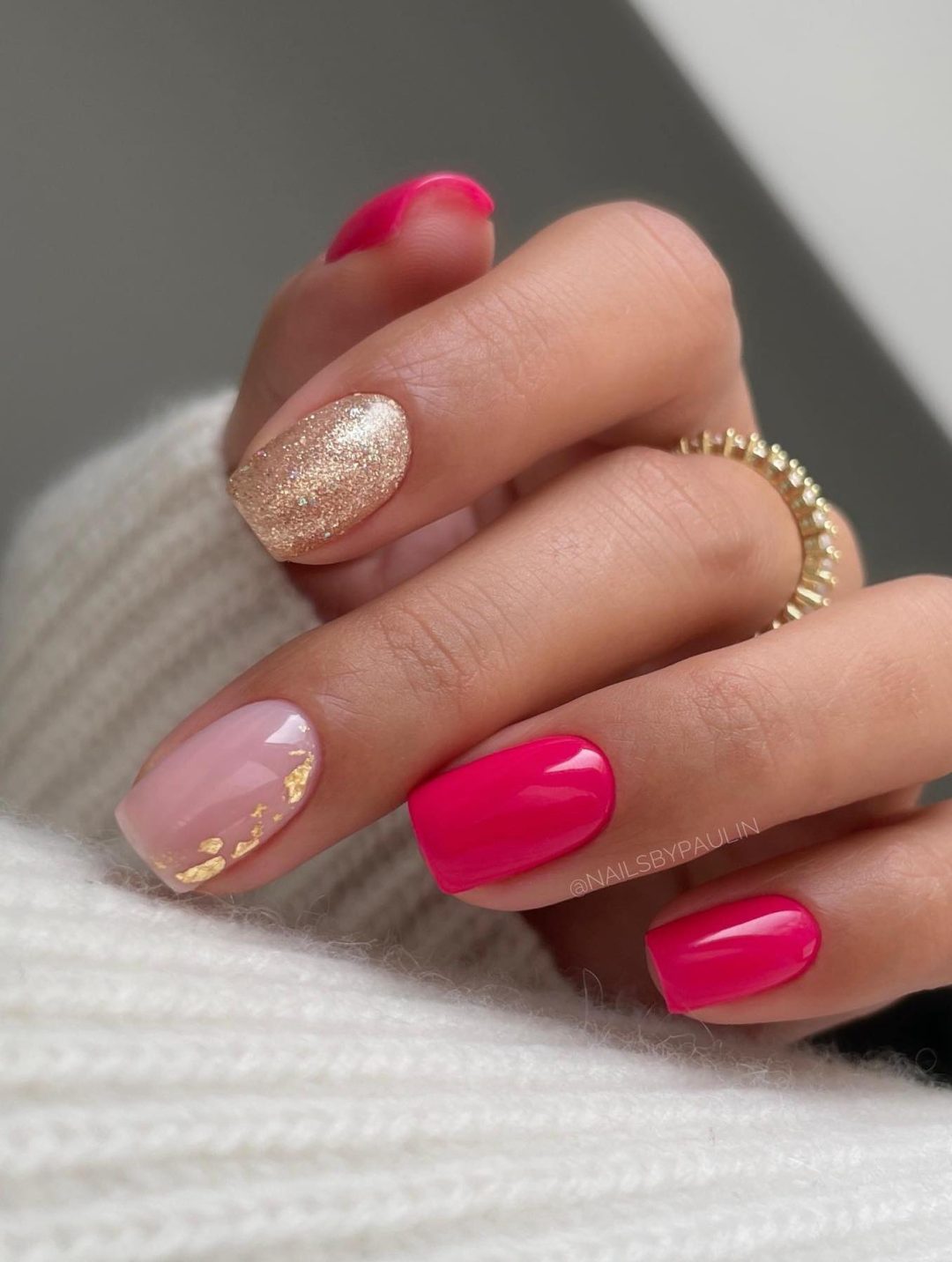 Hot pink nails with gold glitter.