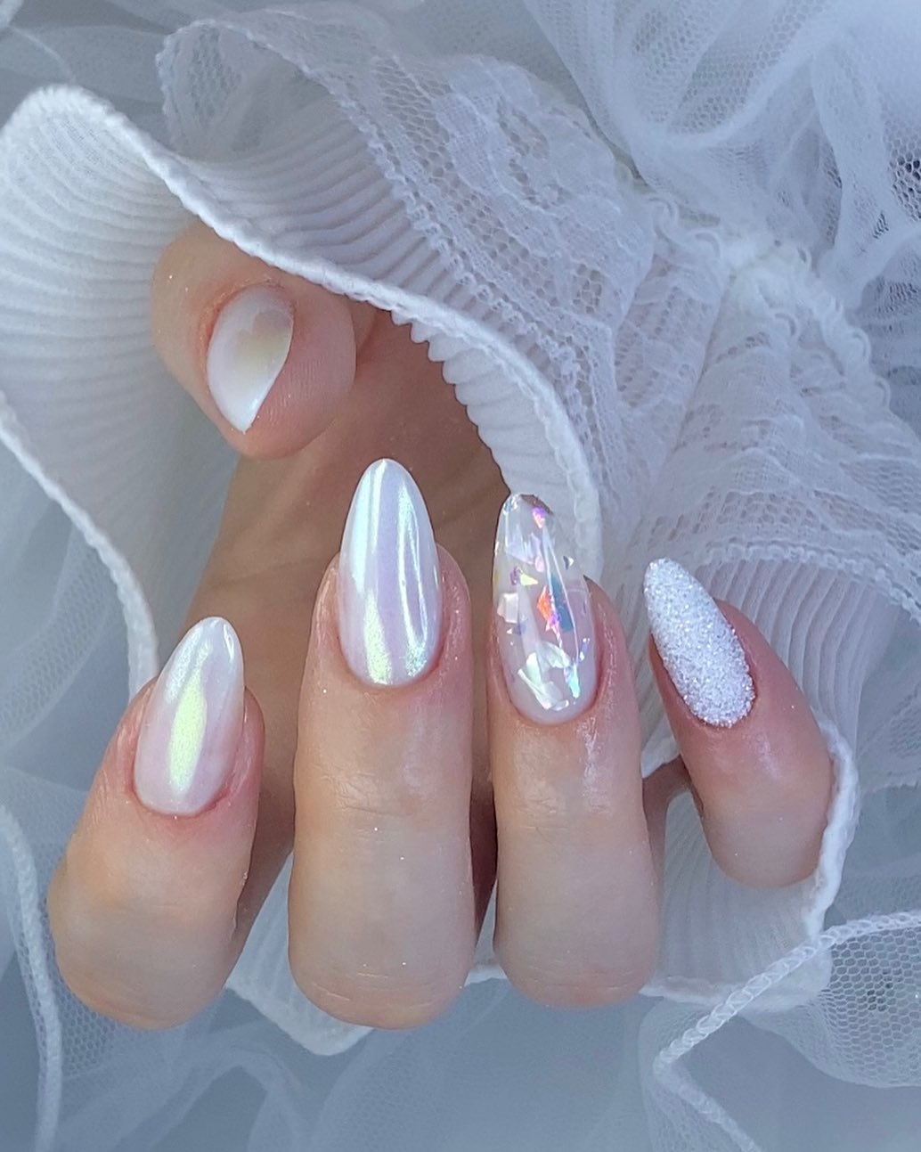 Glazed white nails in almond shape.