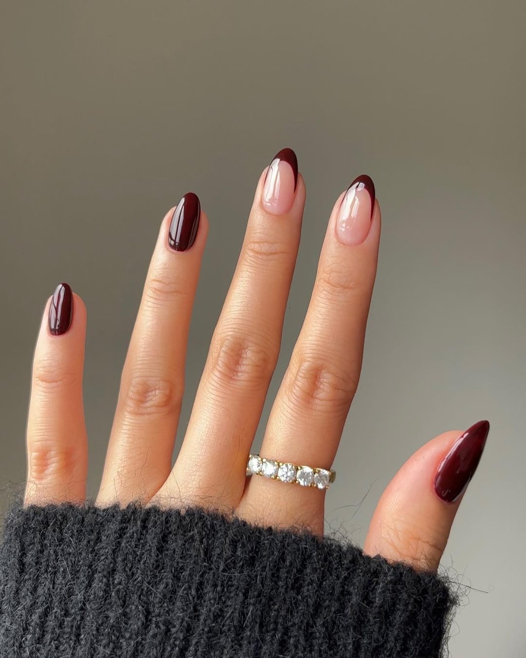 Short burgundy French tip nails.