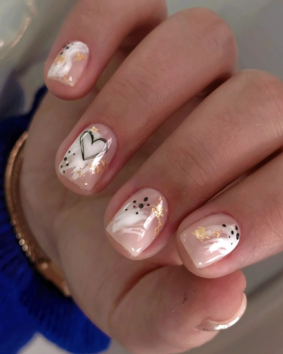 Short white nail designs with a heart.