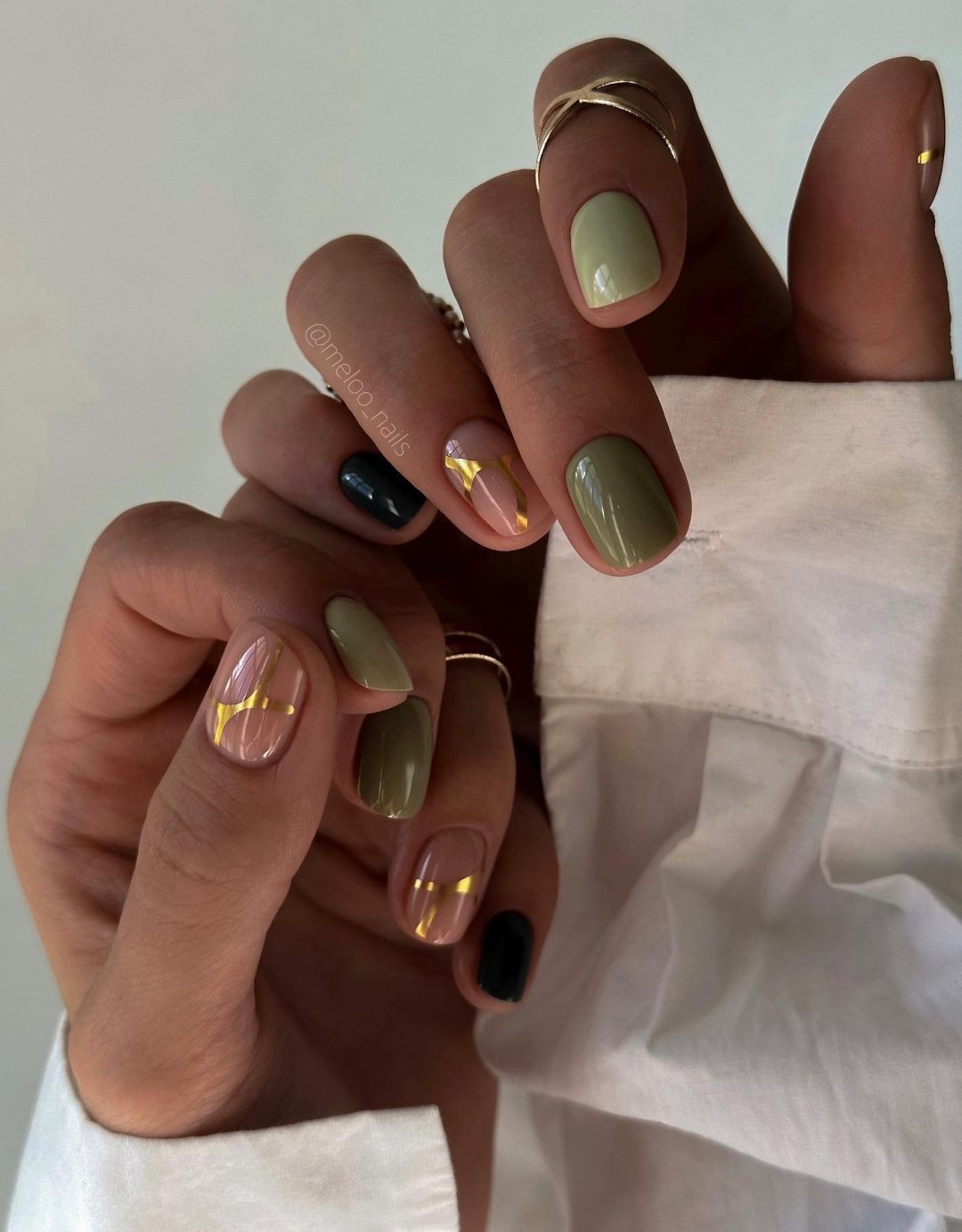 Short olive green nails with gold.