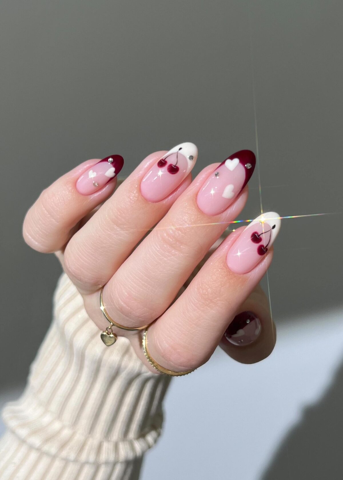 Cute white and burgundy French tip nails with cherries.