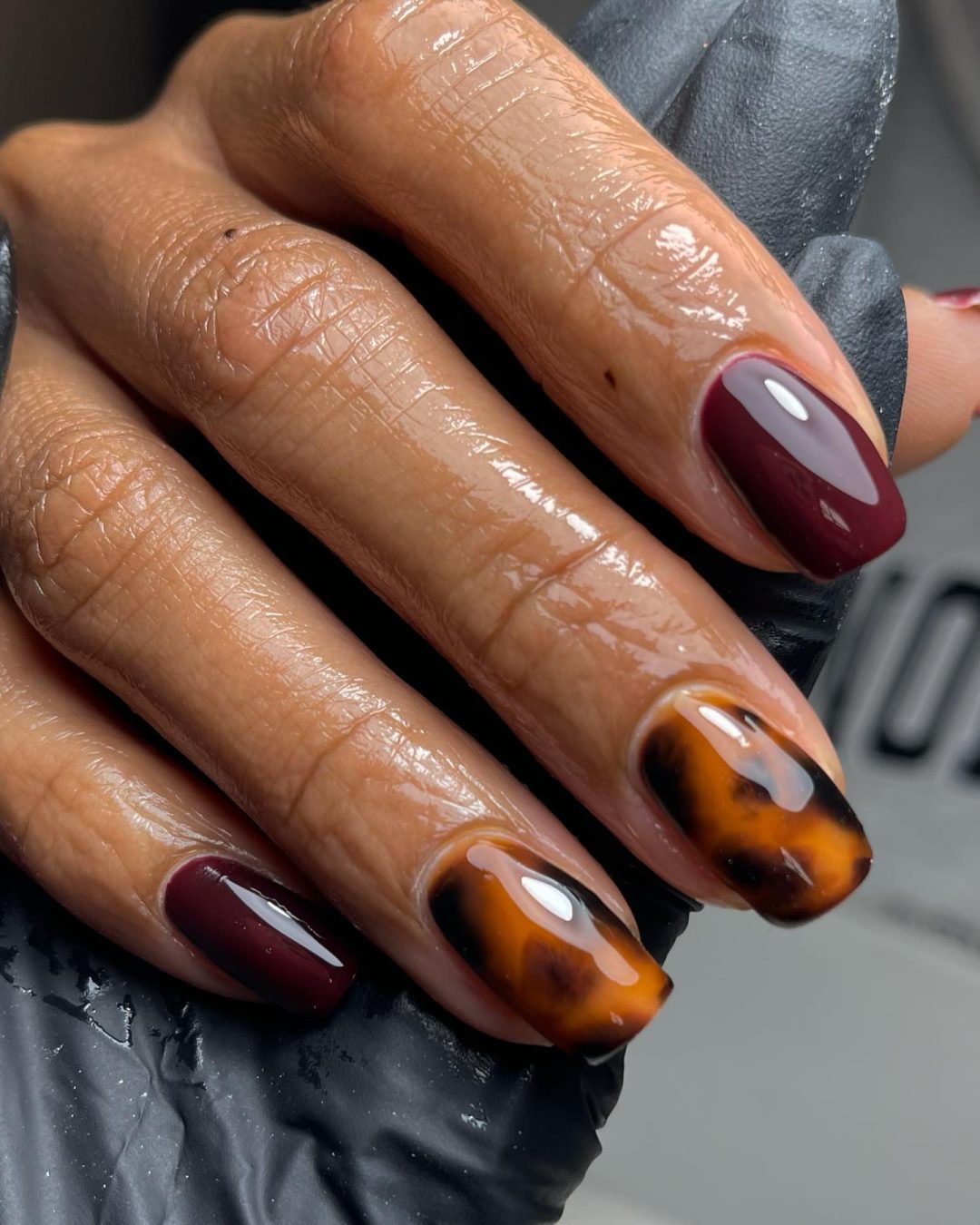 Burgundy nails with tortoiseshell design.