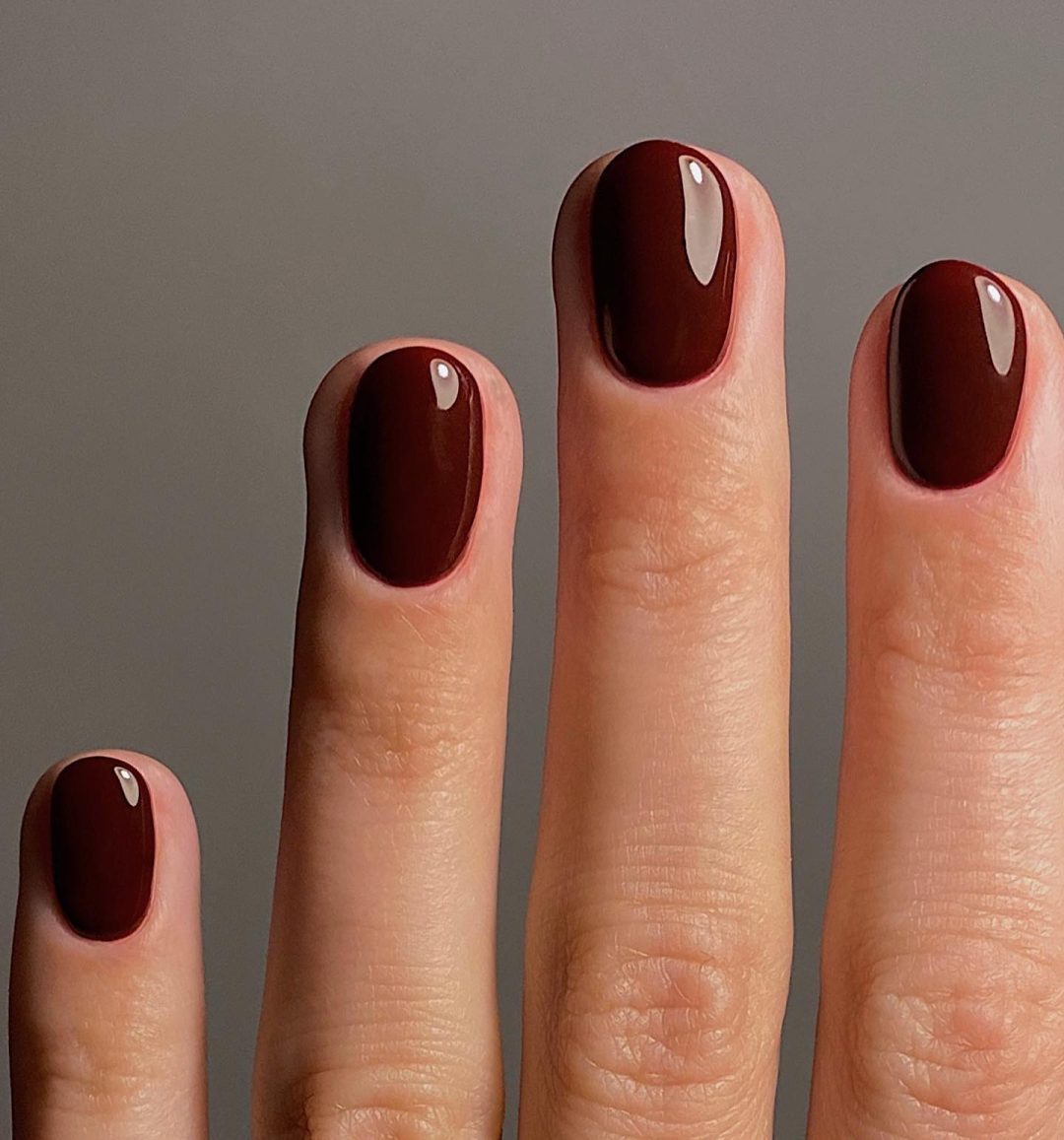 Short burgundy nails.