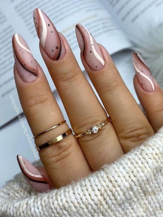 Nude almond nails with swirls