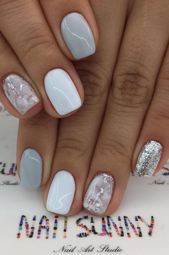 Short light grey ombre nail designs with glitter.