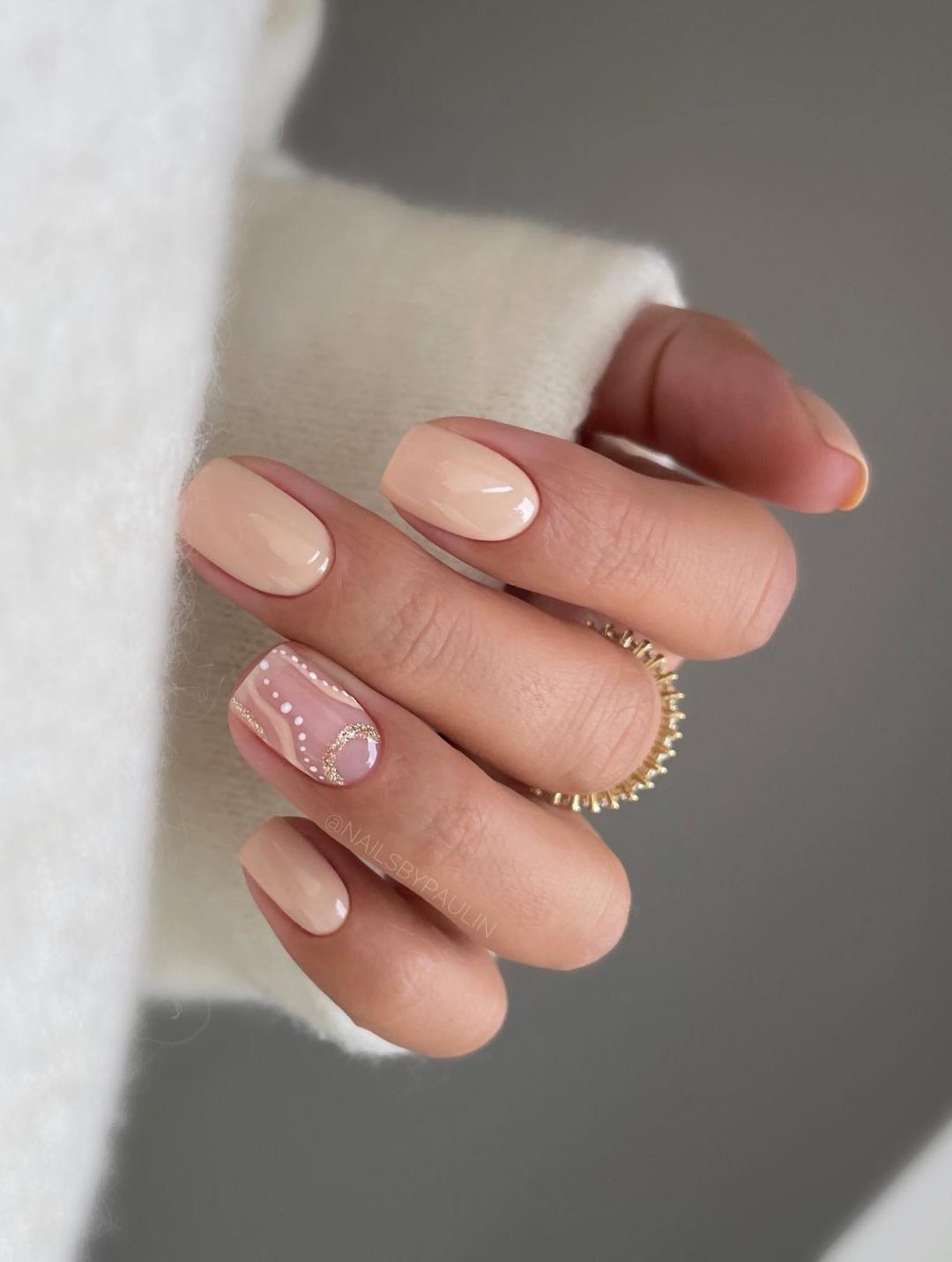 Short beige nails.