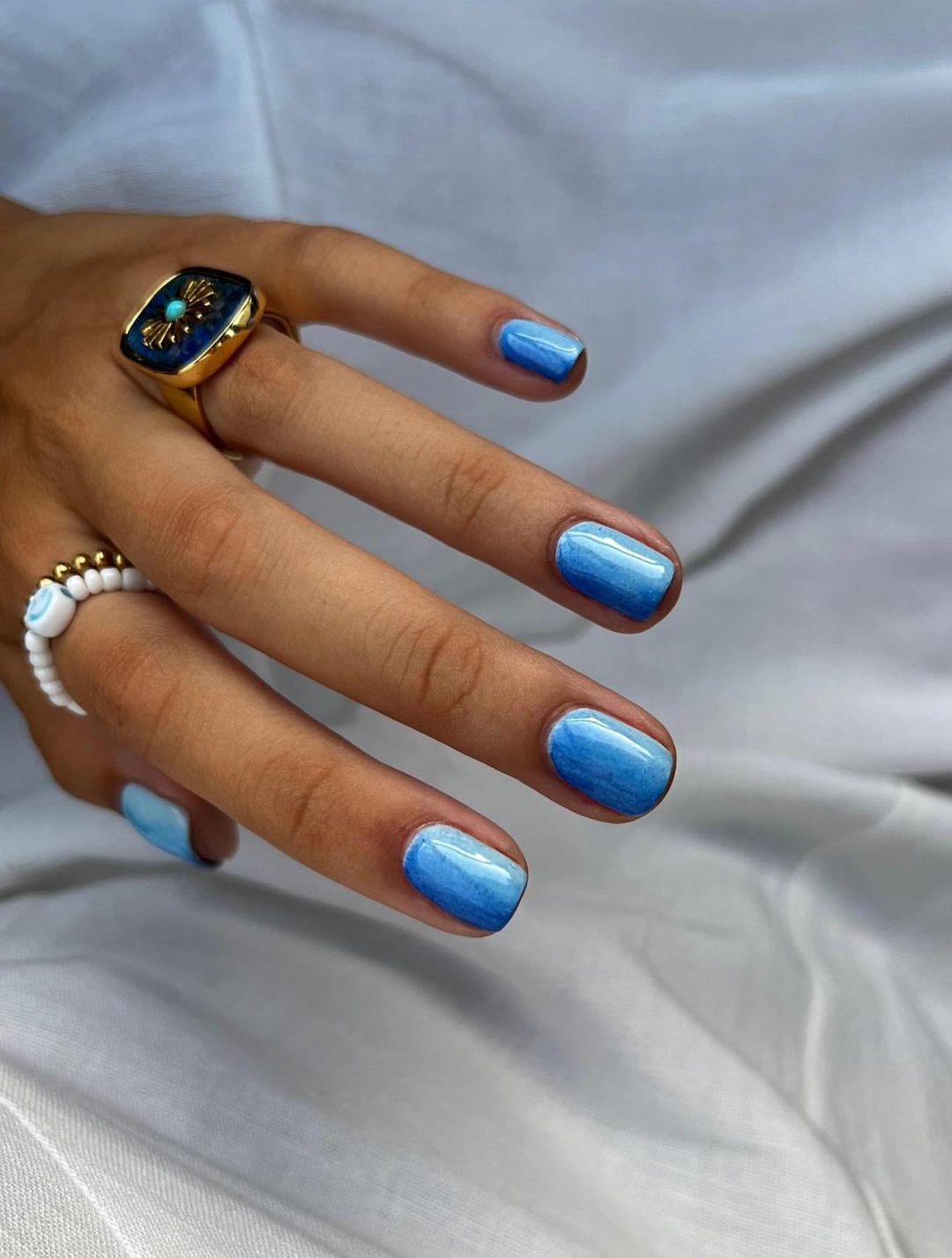 Short blue ombre nails.