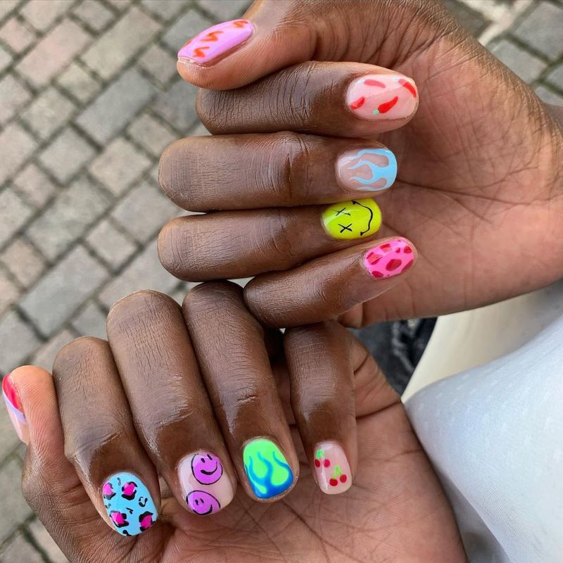 Short colorful mix and match nails with smiley face nail art