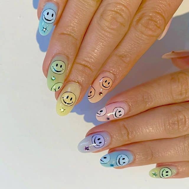 Pastel rainbow ombre nails with smiley nail art