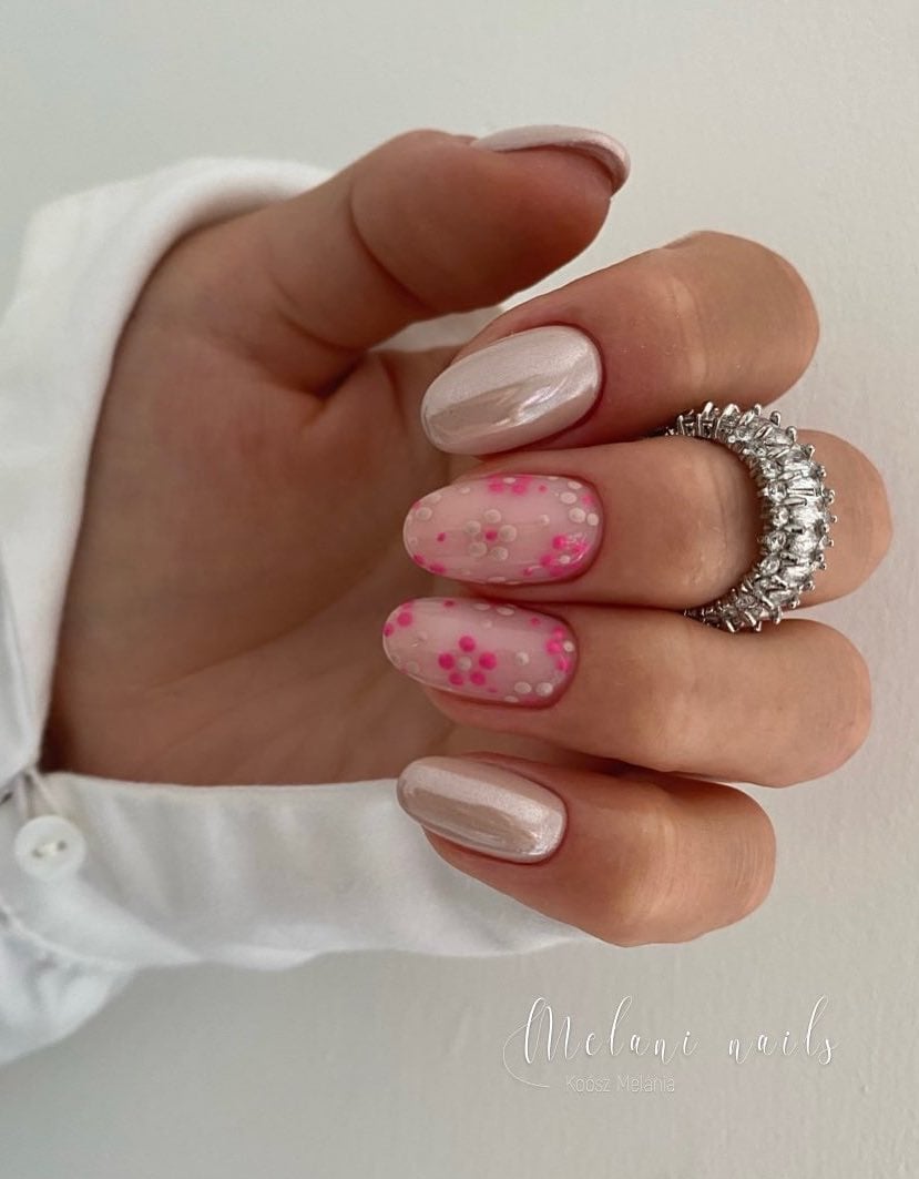 White pearlescent nails with pink flowers.