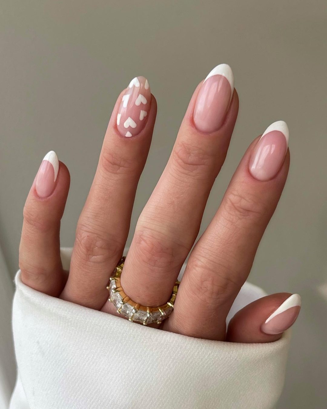 White French tip nails with hearts.