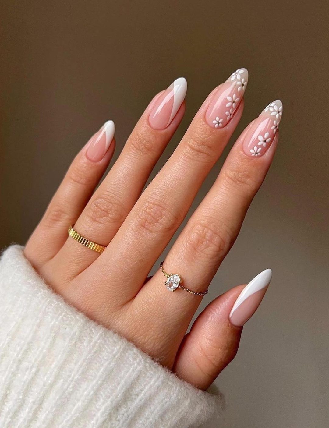 White French tip nails with daisy design.