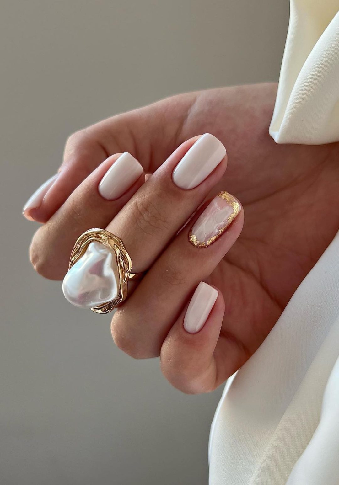 Milky white nails with gold foil.