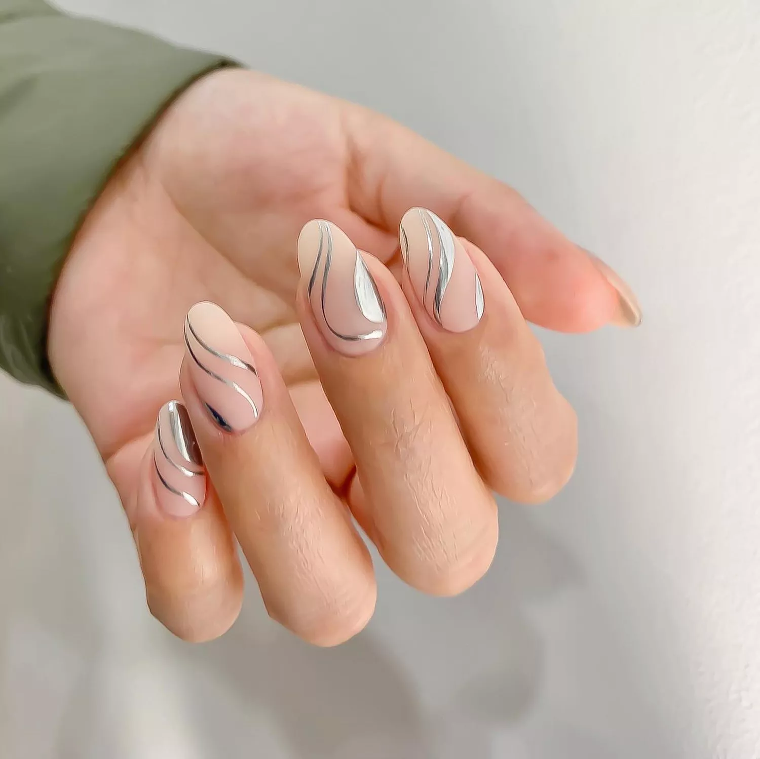 A matte "your nails but better" manicure with chrome swirl accents