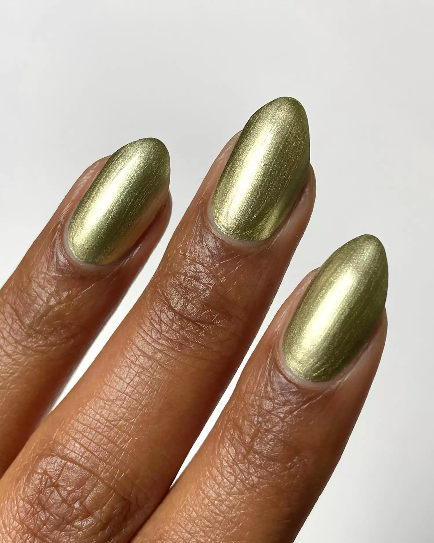 A solid gold chrome manicure