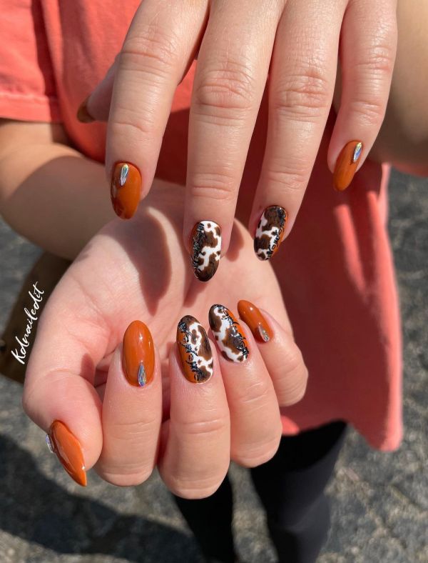 9. Stylish Terracotta and Cow Print Mani